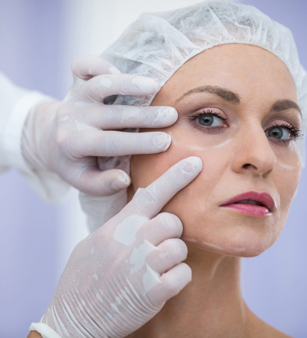doctor-examining-female-patients-face-cosmetic-treatment-scaled.jpg